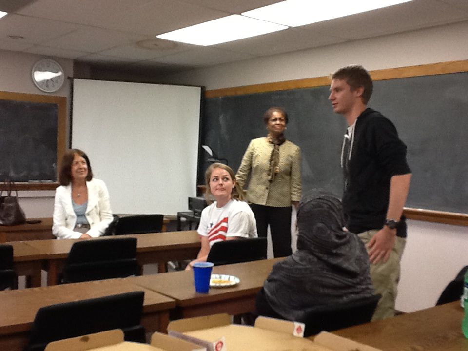 Young male talking in front of class